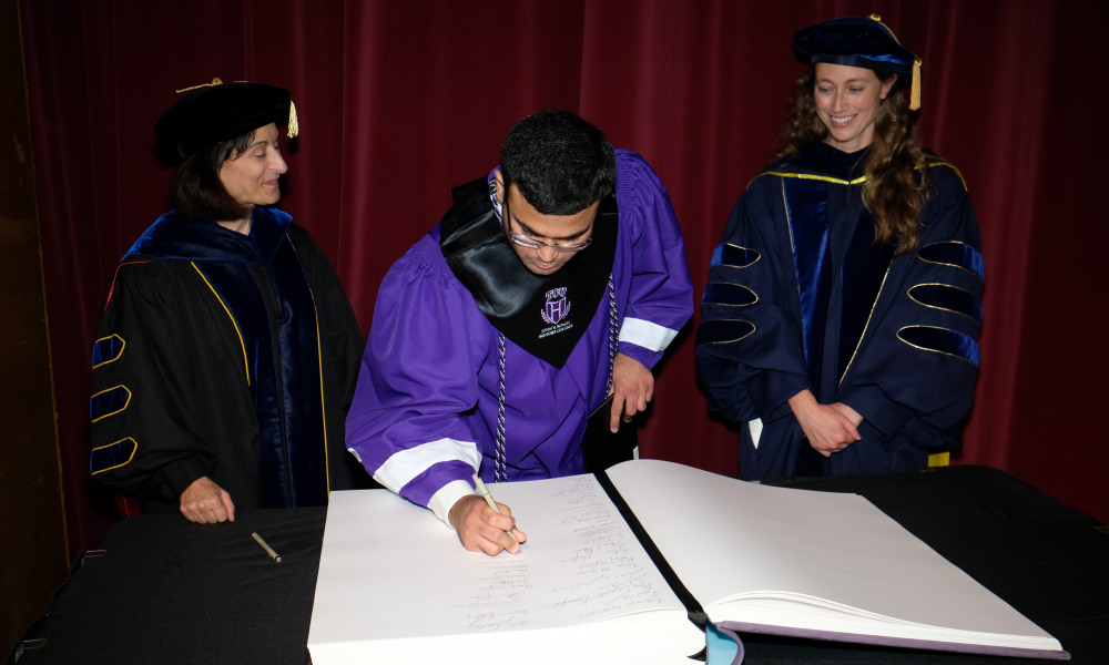 Student signing the Great Book