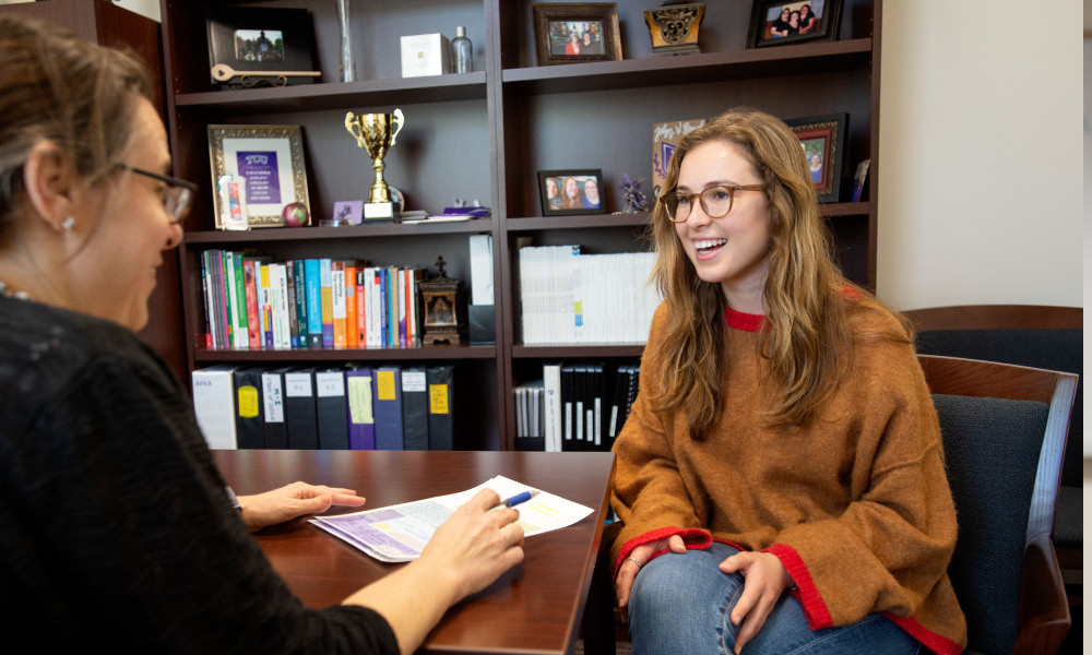 Student talking with a staff member