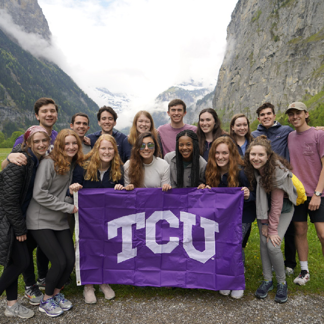 Honors students standing in front of a mountain on a study abroad trip