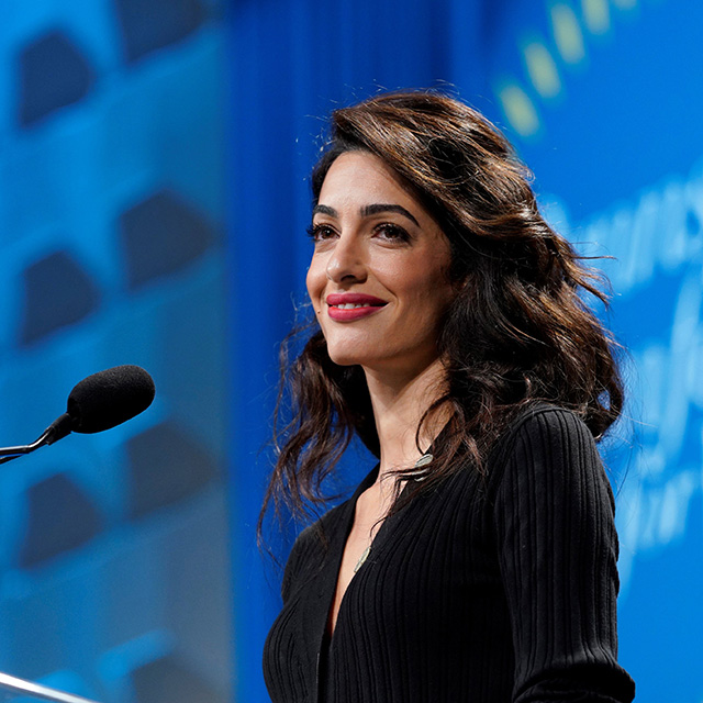Amal Clooney speaking from a lectern