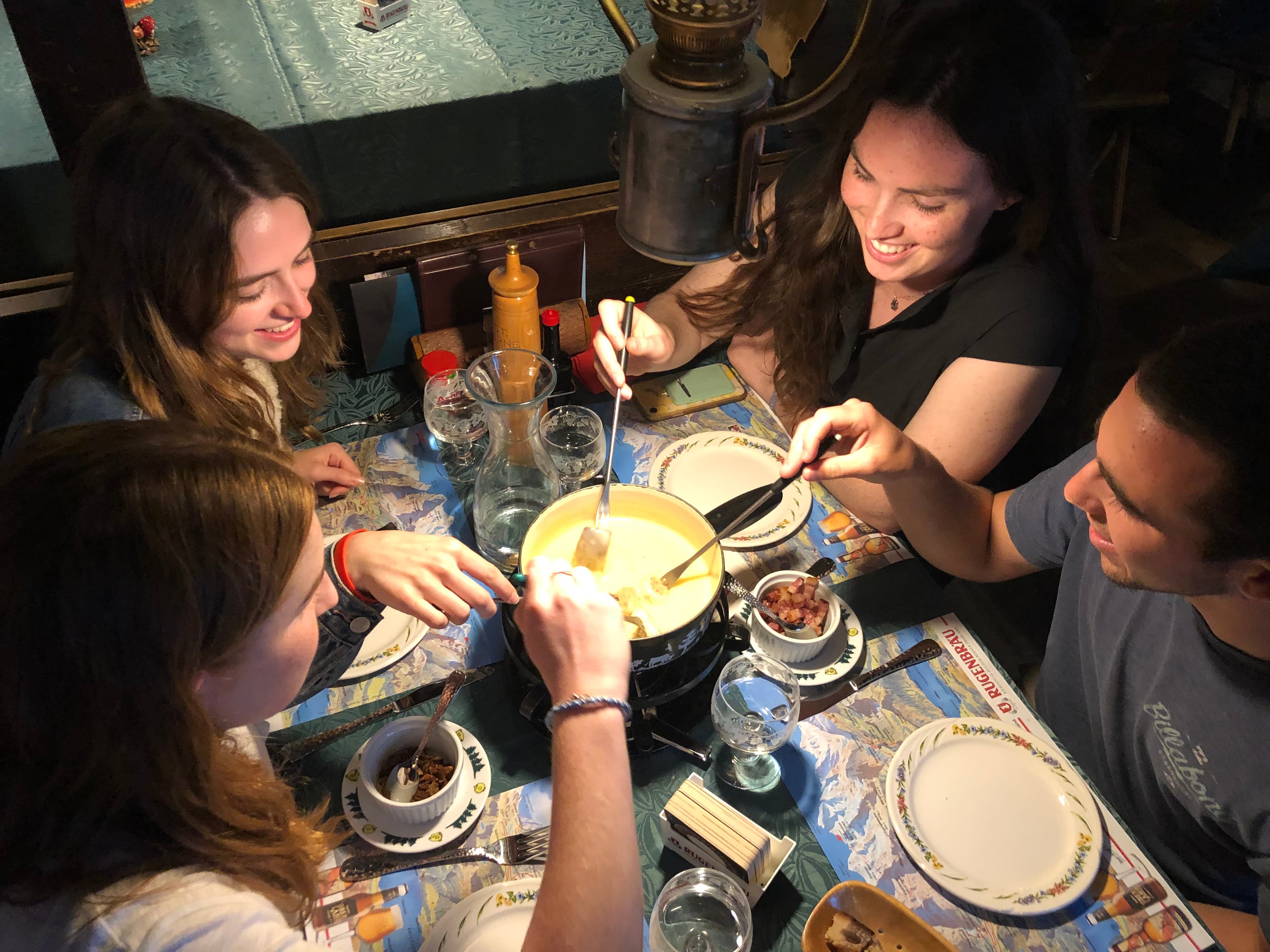 Students eating fondue on a study abroad trip