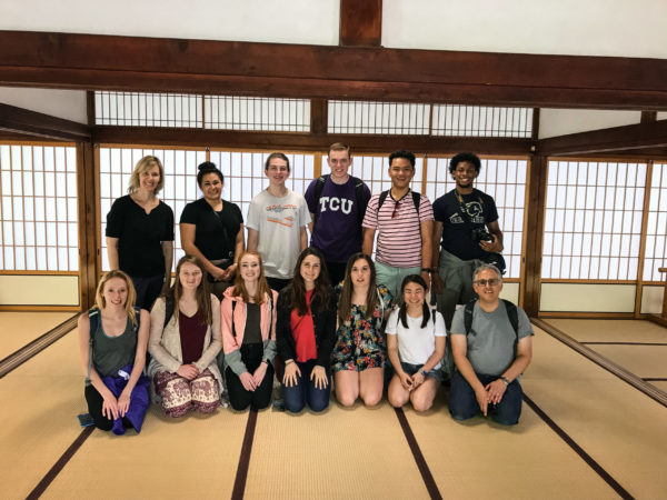 Honors students arranged in two rows inside of a traditional Japanese building