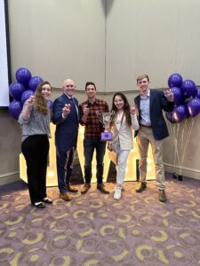 Ron Pitcock poses with four Honors student, all giving the Go Frogs hand sign