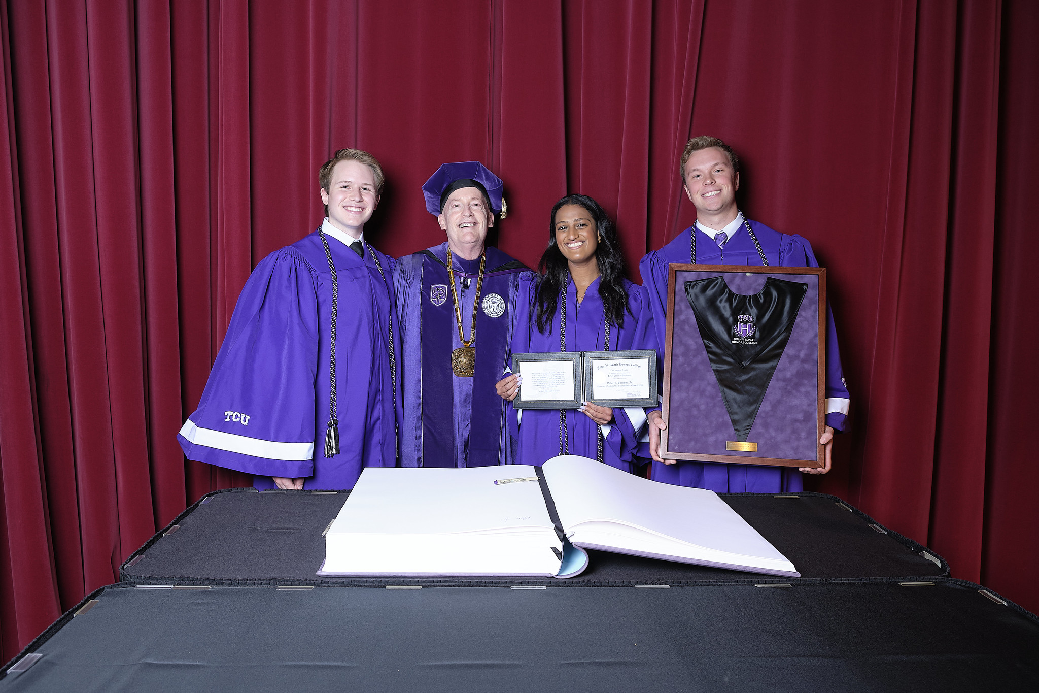 Chancellor Boschini with 3 graduating seniors of the John V. Roach Honors College