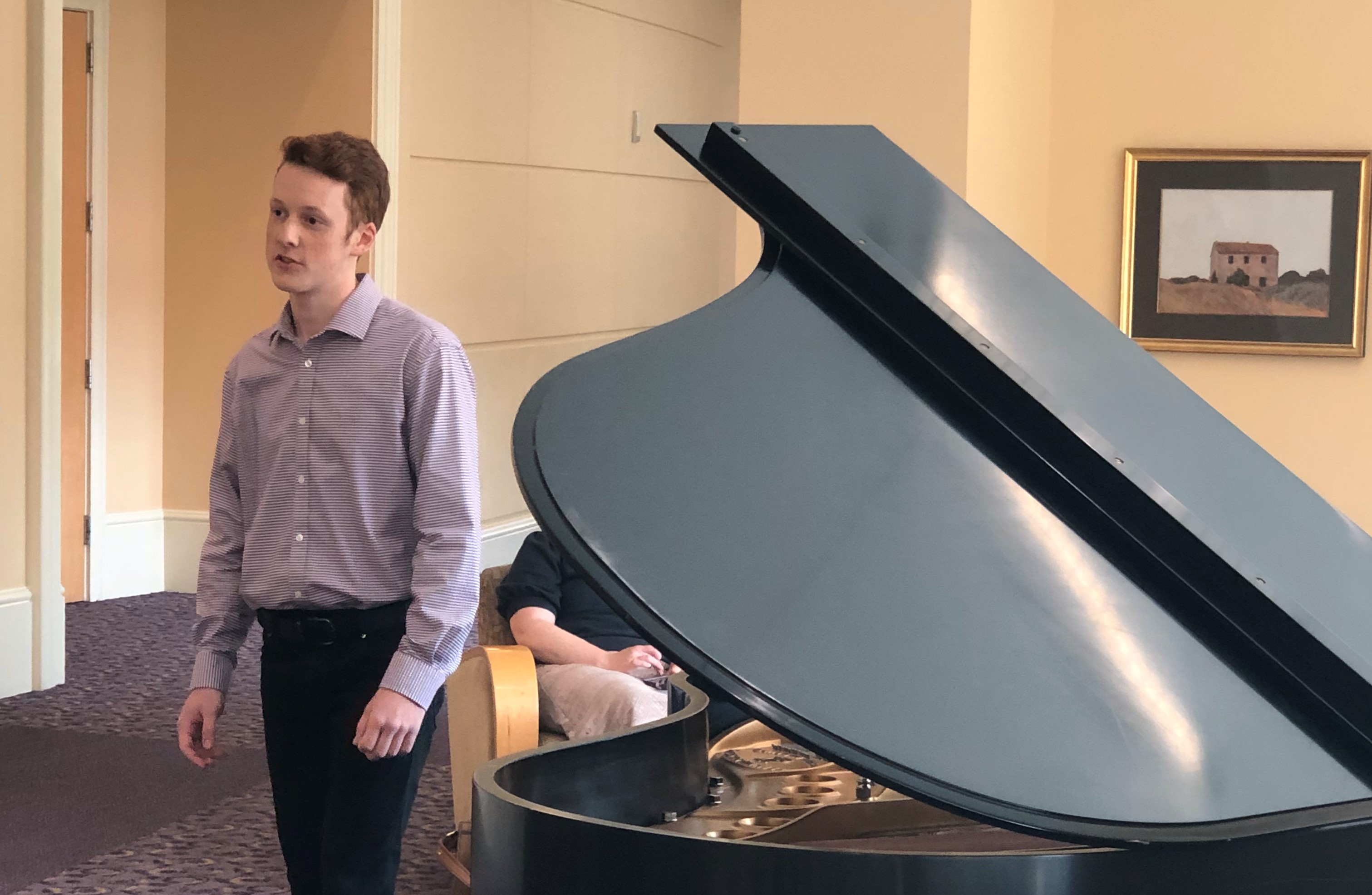 Josh Stanczak, pianist, speaking to the audience at the BLUU concerts