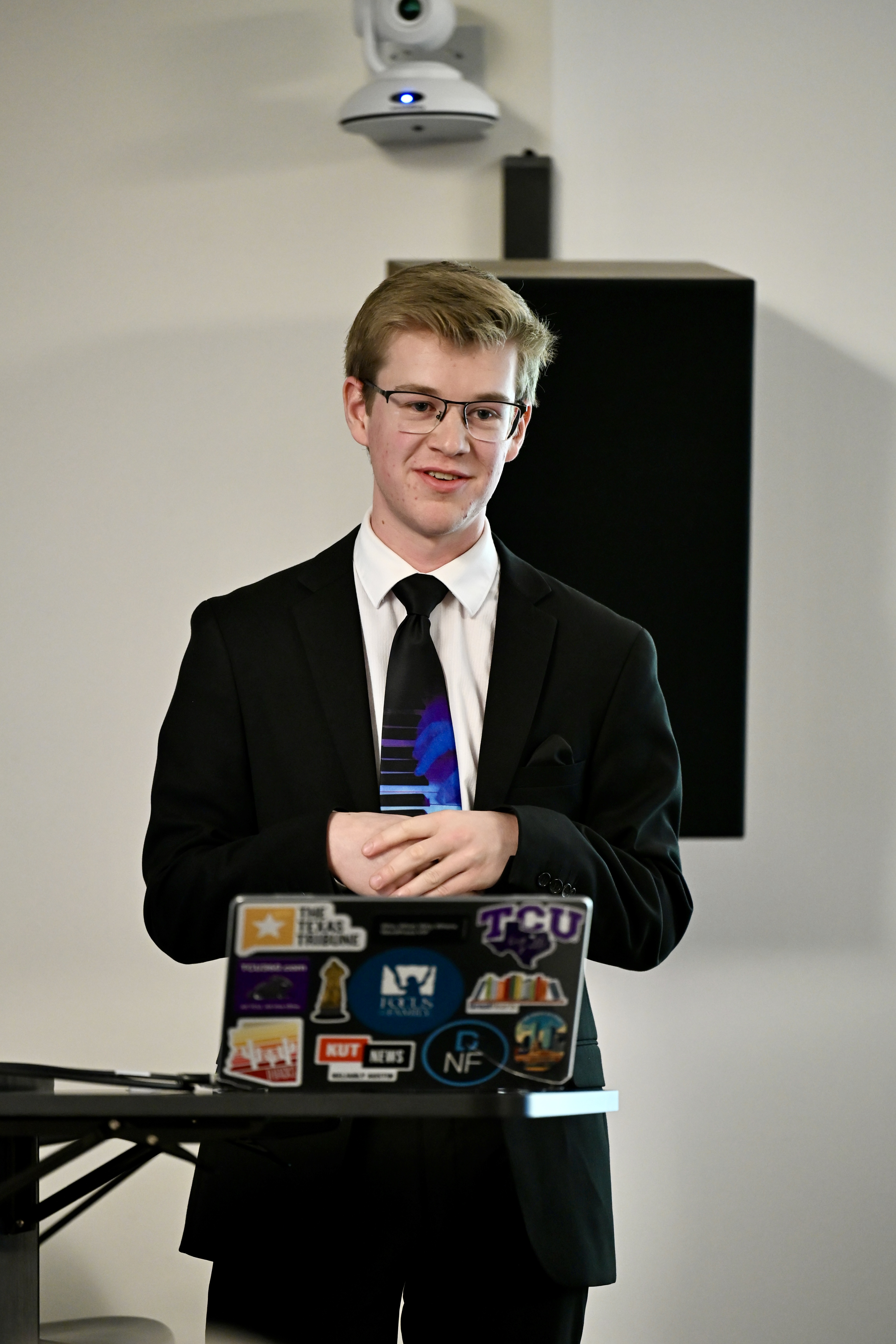Caleb Gottry standing behind his laptop while presenting