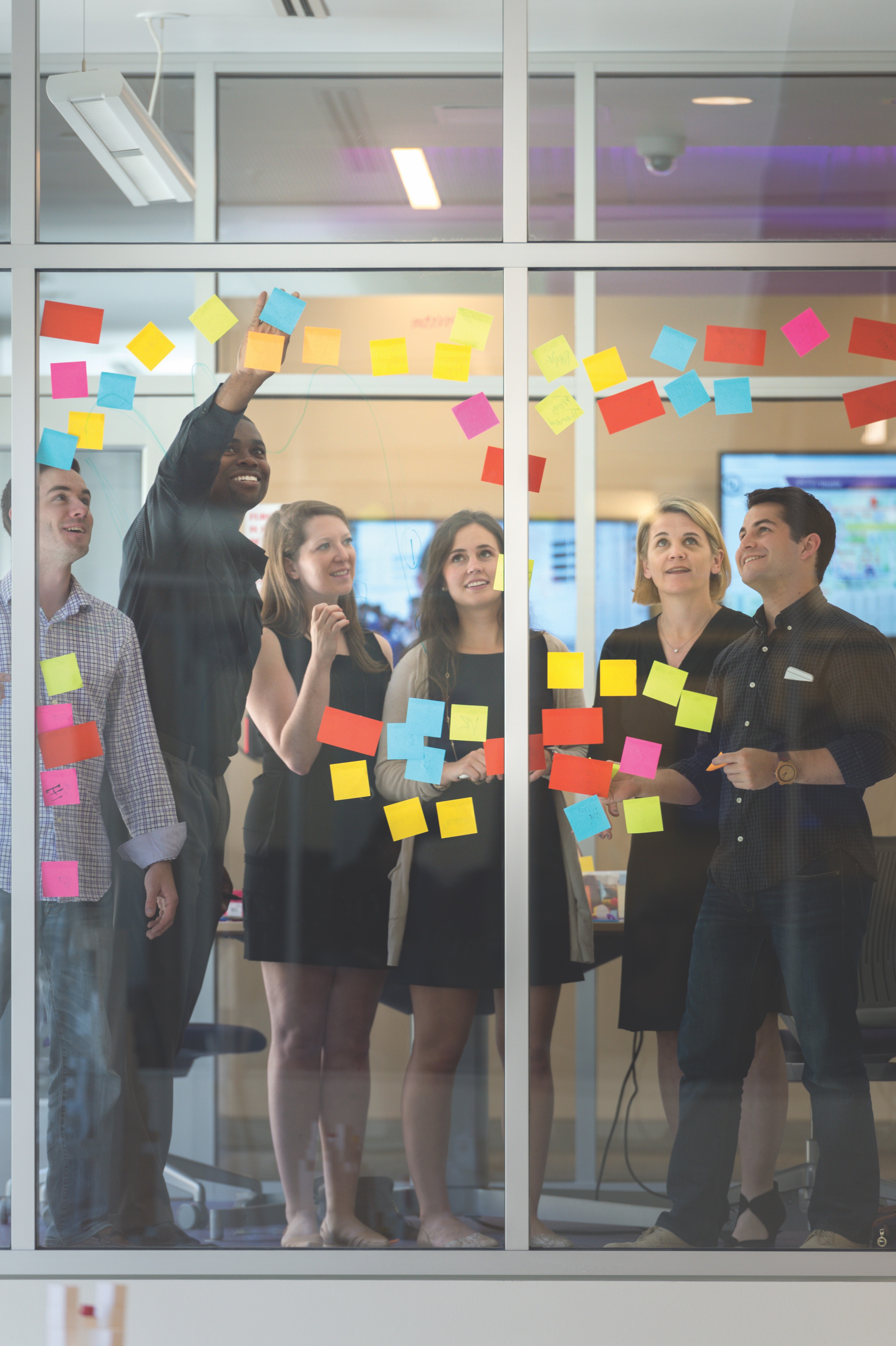 Students use Post-It notes to brainstorm ideas. Photo by Leo Wesson, April 27, 2016